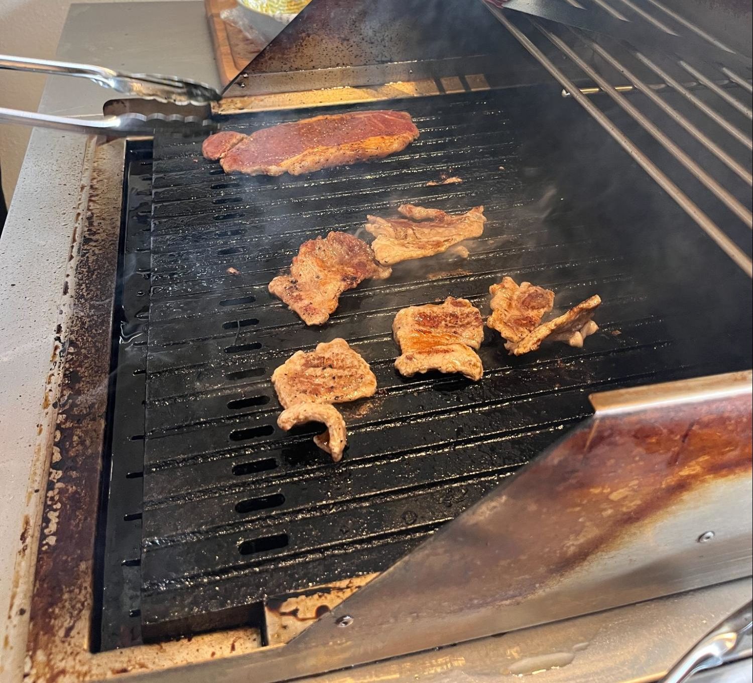 会社のBBQイベントで、大きな本格グリルを使ってジューシーに焼き上げられている美味しそうなお肉